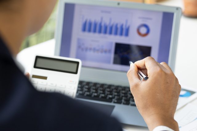 accountant-working-financial-investment-on-laptop-2023-11-27-05-14-27-utc Accountant working financial investment on calculator, calculate, analyze business and marketing growth on financial document data graph, Accounting, Economic, budget planning.