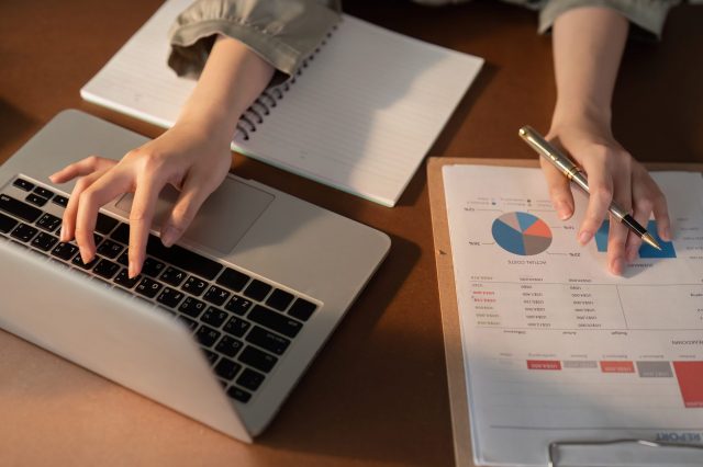 Businesswoman using laptop computer and working at office with calculator document on desk, doing planning analyzing the financial report, business plan investment, finance analysis concept Businesswoman using laptop computer and working at office with calculator document on desk, doing planning analyzing the financial report, business plan investment, finance analysis concept.